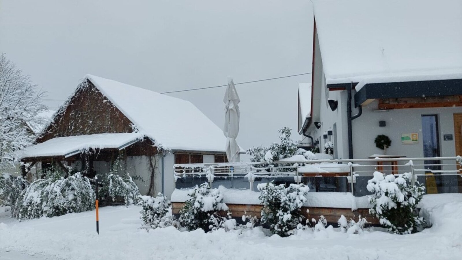 The exterior of the Farm House and its grounds, covered in snow during winter.