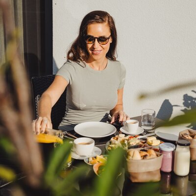 Outdoor breakfast on the terrace of the Bauernhof, featuring a selection of food and drinks.