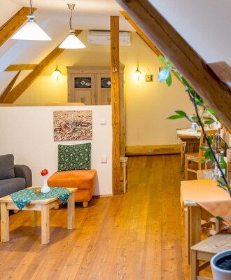 The living area of the farmhouse with oiled larch wood floors, wooden beams, and solid wood furniture.