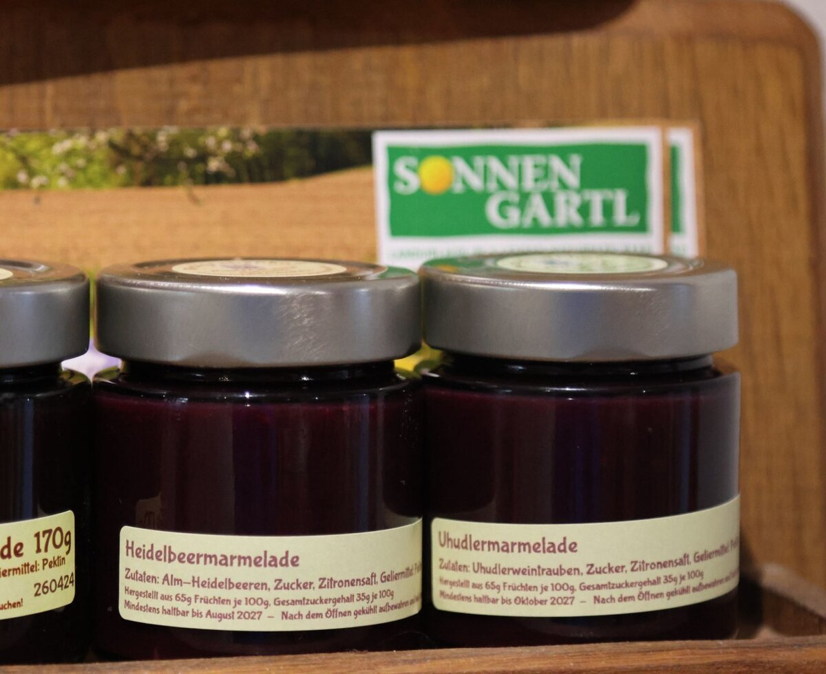 Jars of local blueberry and Uhudler grape jam, available as products at the farmhouse.