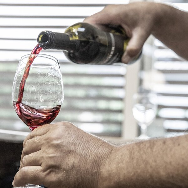 A glass of red wine is poured, available as an offering at the farmhouse. A glass of red wine is poured, available as an offering at the farmhouse.