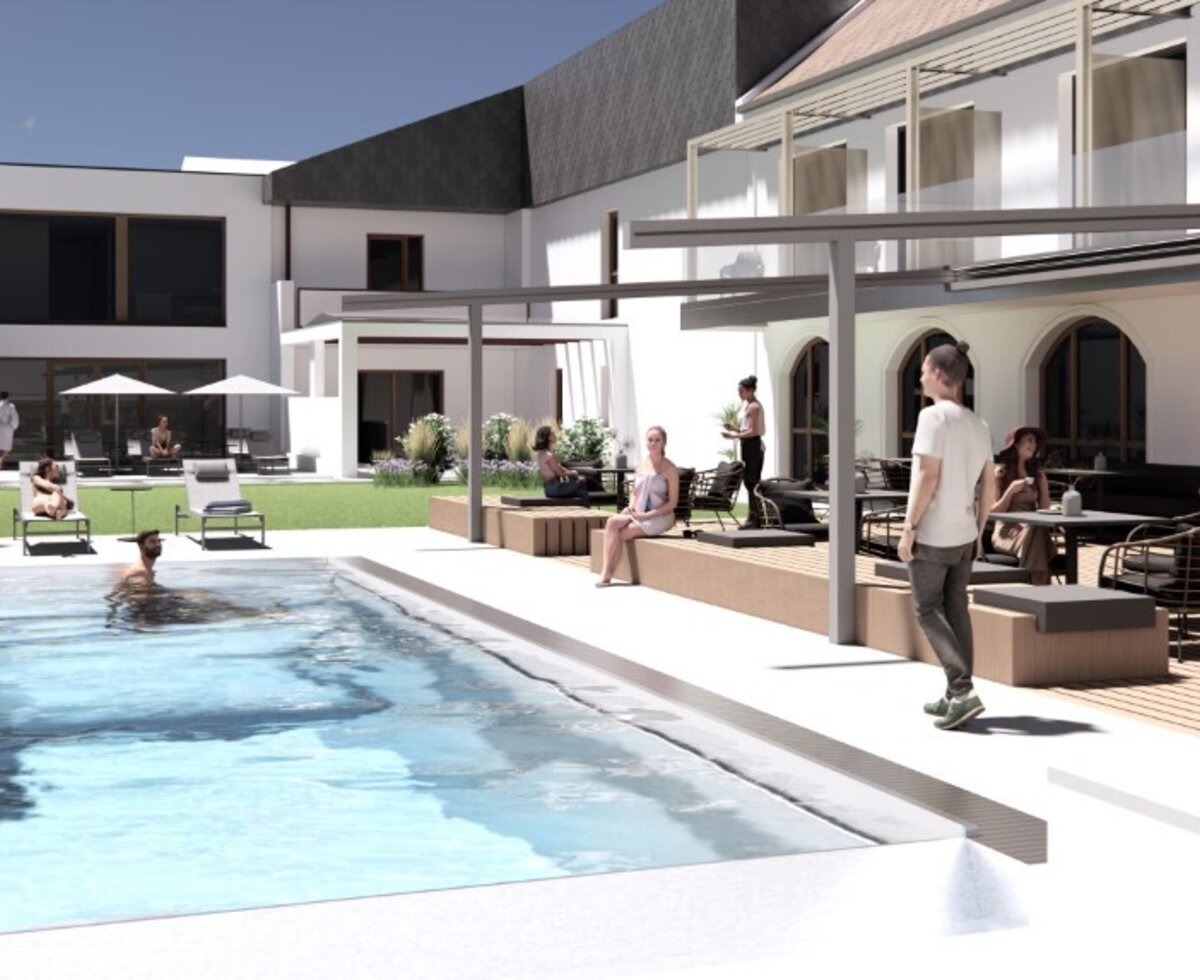 The outdoor area of the Haus, featuring a swimming pool, sun loungers, and a terrace.