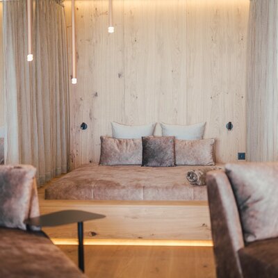 The air-conditioned relaxation room in the farmhouse's wellness area, featuring multiple loungers and wooden paneling.