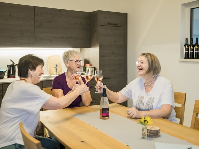 The farmhouse's modern kitchen and dining area, featuring a wooden table for shared meals and socializing.