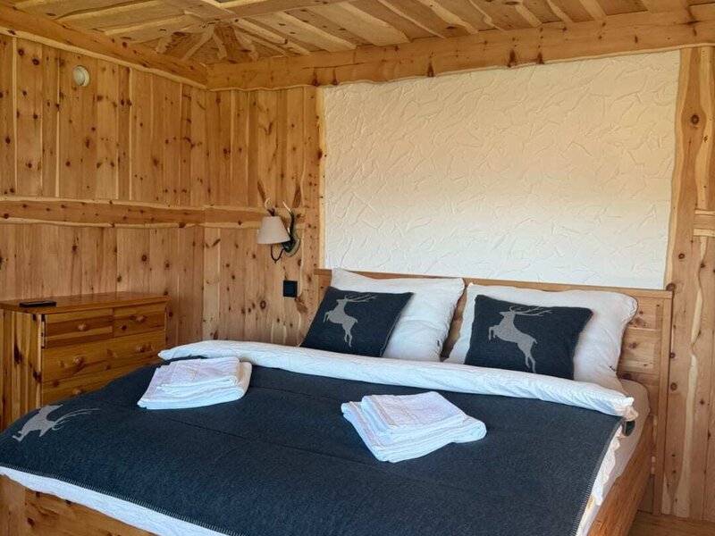 The Swiss stone pine room is a stylish alpine retreat featuring a double bed, warm pine wood and thoughtfully selected details.