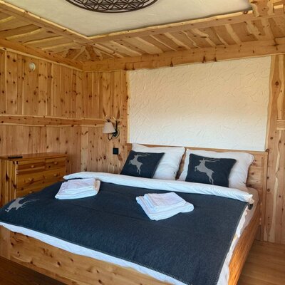 The Swiss stone pine room is a stylish alpine retreat featuring a double bed, warm pine wood and thoughtfully selected details.