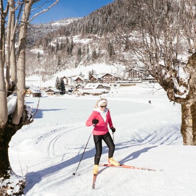 Cross-country skiing in the snowy landscape surrounding the Farm House, with views of the village and mountains.