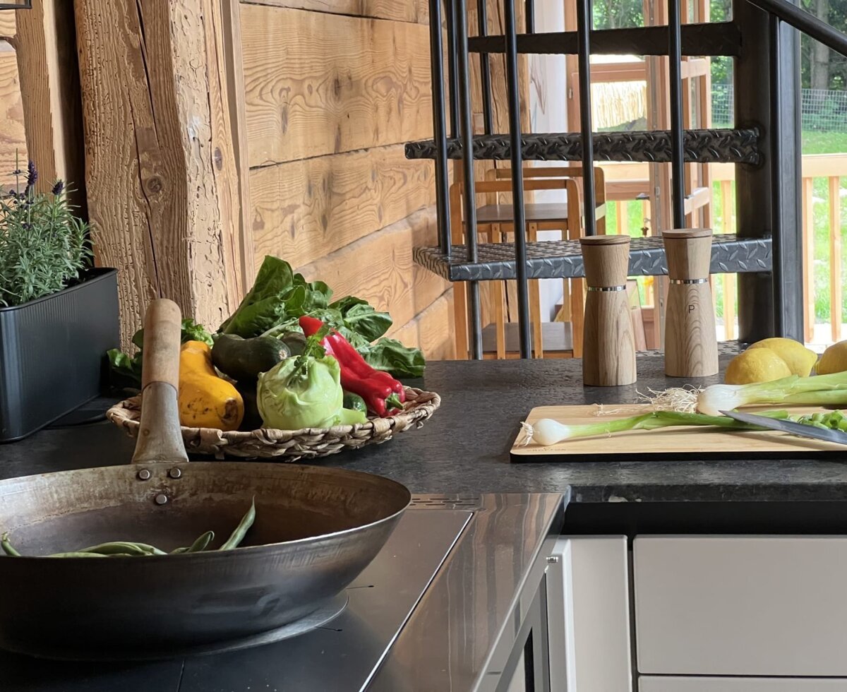 The fully equipped kitchen of the holiday home, featuring fresh ingredients and cooking utensils for meal preparation.