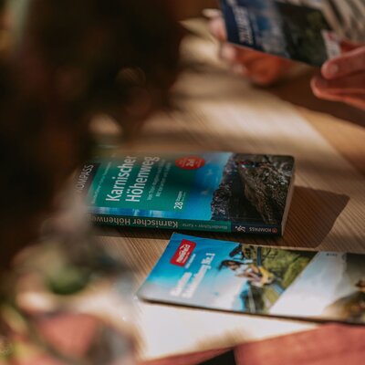Hiking maps and brochures on a table at the farmhouse for planning excursions and activities.
