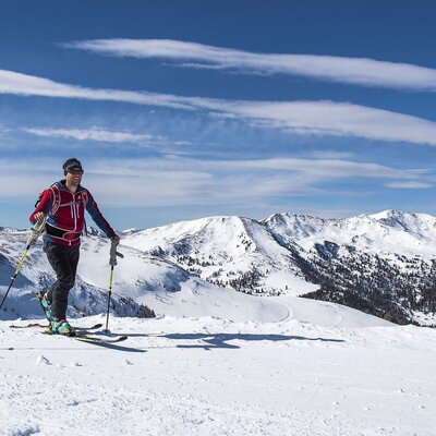 A ski tourer in the snowy mountain landscape, a popular winter activity in the area.