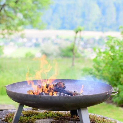 The Farm House features an outdoor fire pit with a burning fire.