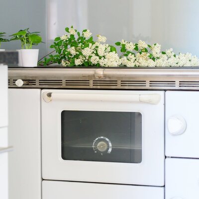 The farmhouse kitchen is equipped with a white REGA range cooker, featuring an oven and stovetop.