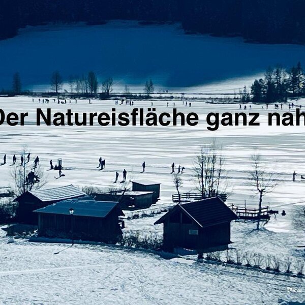 The frozen Weissensee lake with people ice skating and walking, accessible from the Farm House.