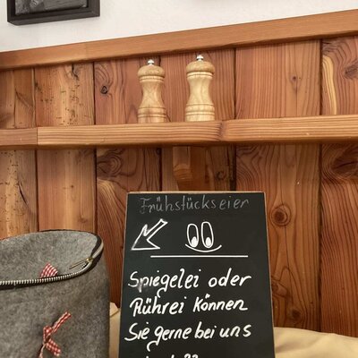 Blackboard sign at the farmhouse informing guests that fried eggs or scrambled eggs can be ordered for breakfast.