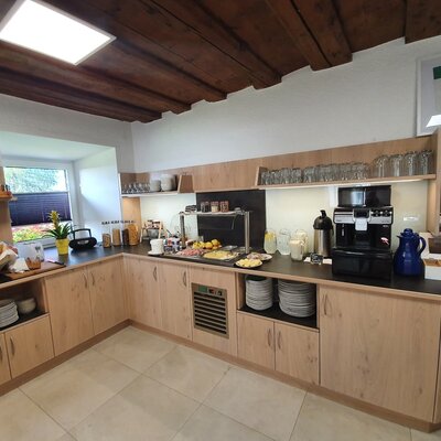 The Farm House breakfast buffet offers a selection of pastries, cold cuts, cereals, fruit, and hot beverages for guests.