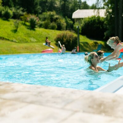 The farmhouse's outdoor pool, offering swimming fun for families.