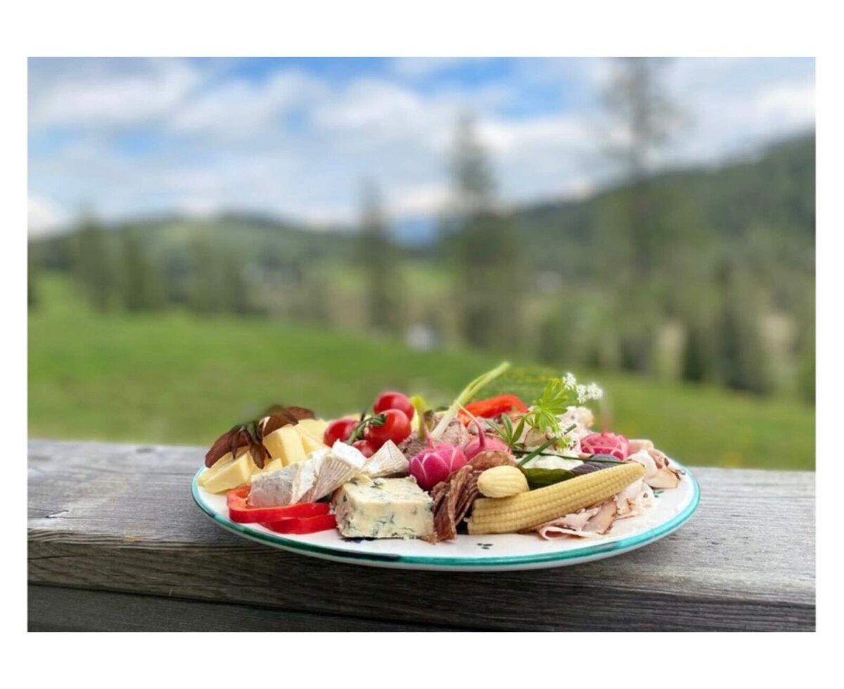 Enjoy a platter of cheeses, cold cuts, and fresh vegetables with mountain views from the Alpine Hut.