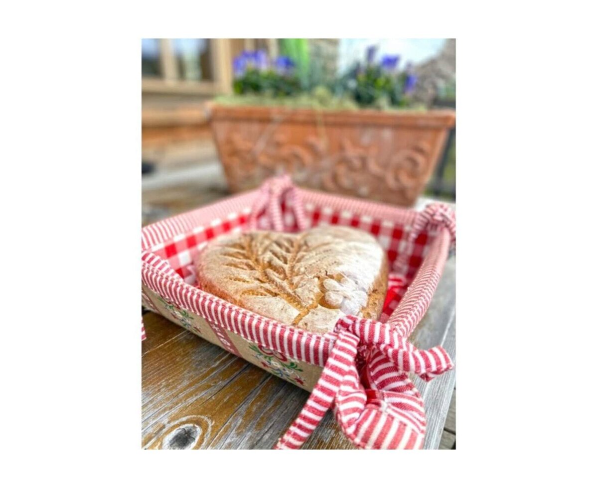 Heart-shaped bread served in a red and white checkered basket at the Alpine Hut.