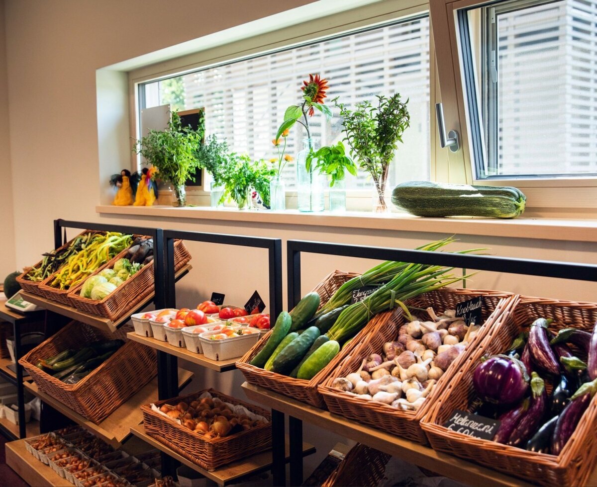 The inviting on-site organic farm shop with a colorful selection of freshly harvested vegetables and herbs.