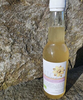 A 320 ml bottle of organic elderflower syrup, a product from the farm.