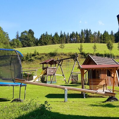 The farm house offers an outdoor playground area with a trampoline, swings, a slide, and a seesaw.