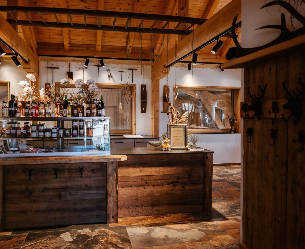 Farm shop at the Bauernhof, featuring a counter and a display case with regional products.