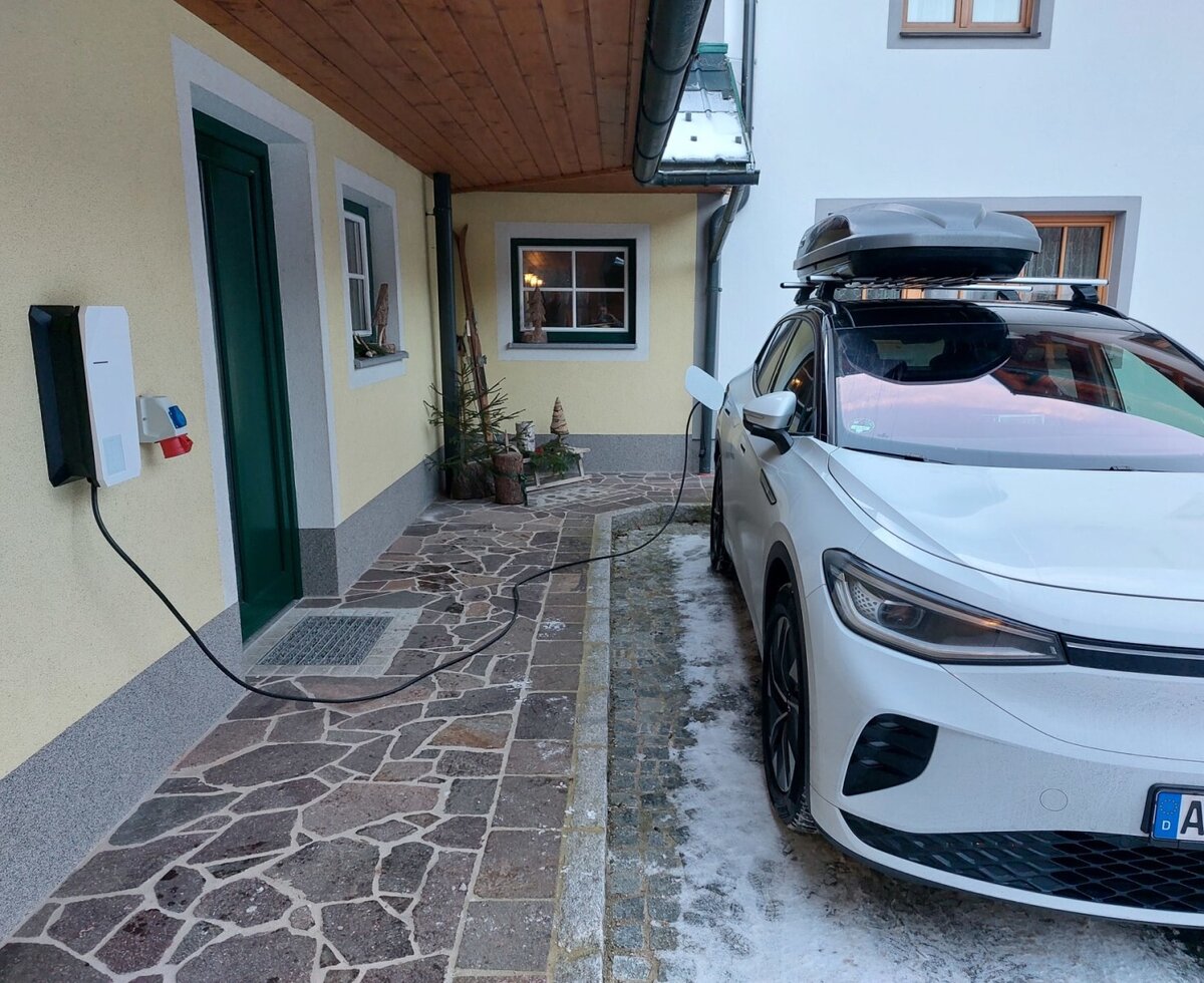 Electric vehicle charging station on the exterior wall of the farmhouse for charging your vehicle.