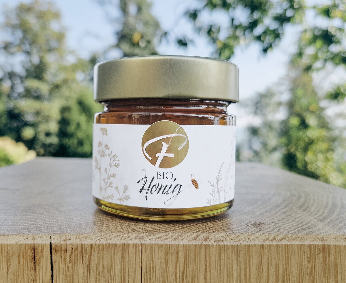 A jar of organic, farm-fresh honey produced on-site, welcoming guests to the apartment.