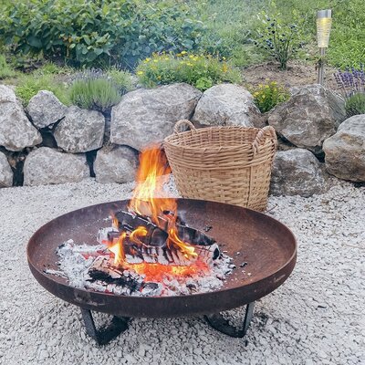 The apartment's inviting fire pit offers cozy evenings by a crackling fire set against an idyllic stone garden.