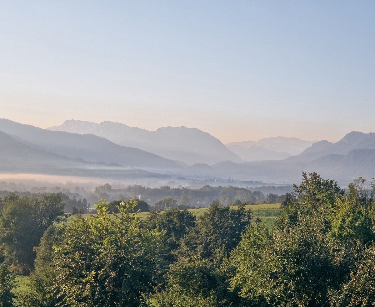 Scenic morning view from the apartment overlooking the misty Alpine foothills.