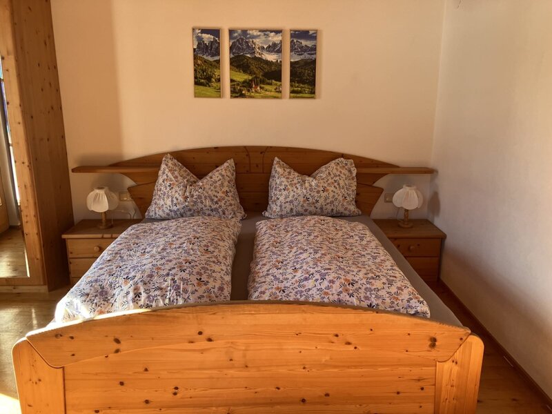 Sunny bedroom with double bed and balcony.