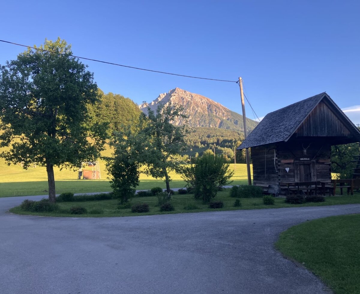 The wooden hut on the Bauernhof with outdoor seating and mountain views.