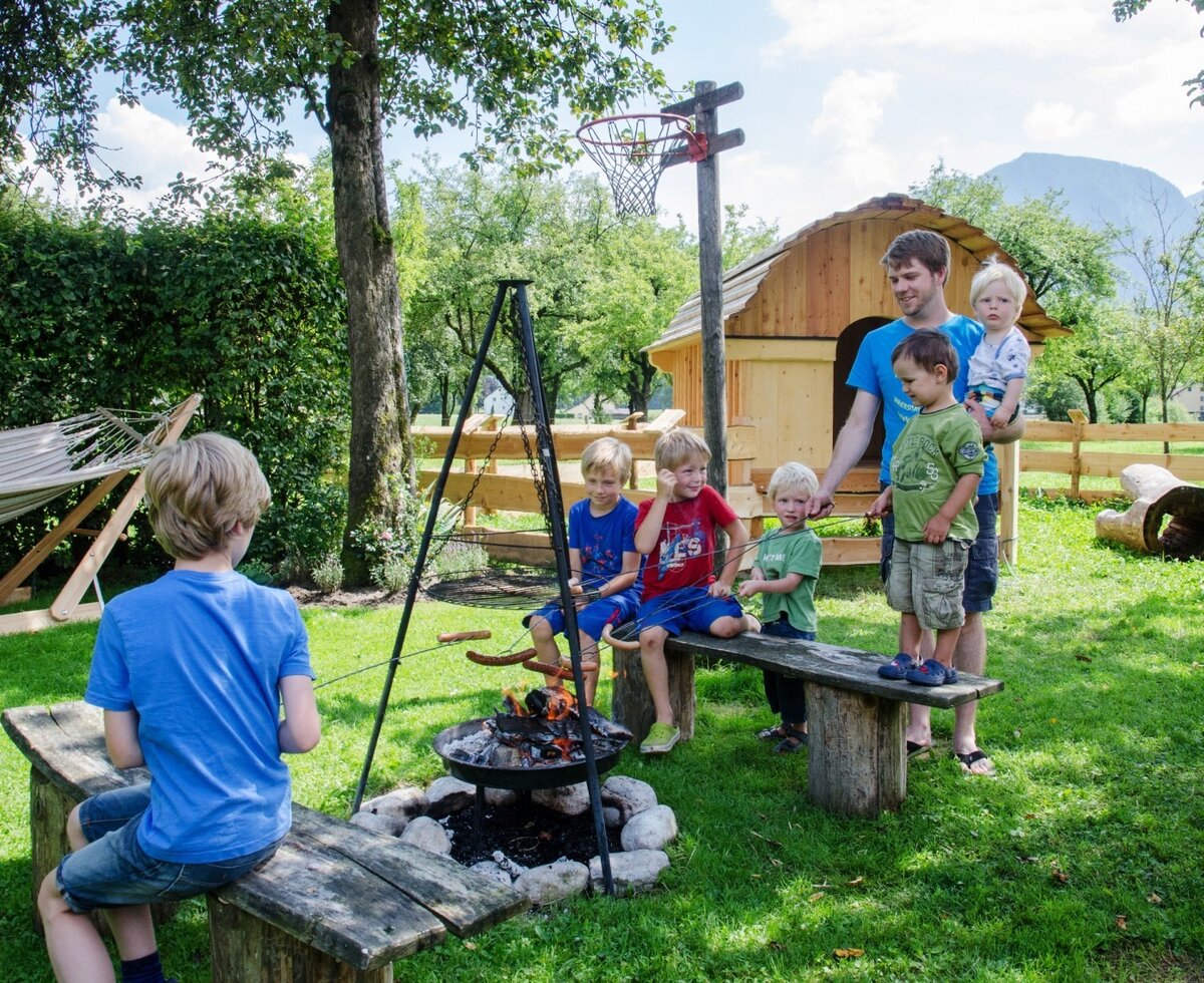 The farm house garden offers a campfire pit for roasting, a wooden playhouse, and a hammock for guest enjoyment.