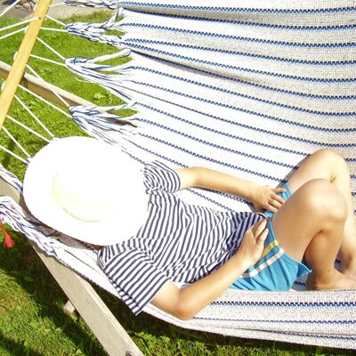 A child lies in a hammock.