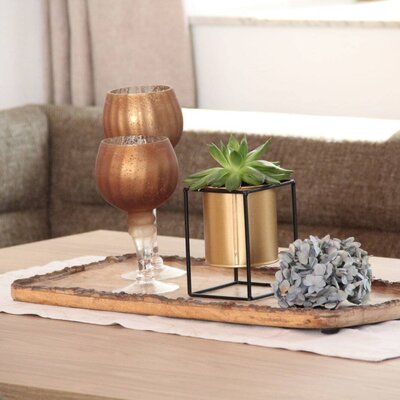 The living room of the Farm House, equipped with a sectional sofa and a wooden coffee table featuring decorative items.