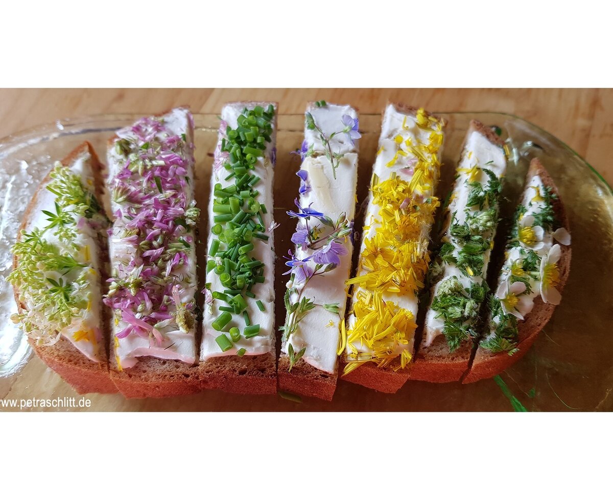 Sliced bread with a savory spread, topped with fresh herbs and edible flowers, available at the Farm House.