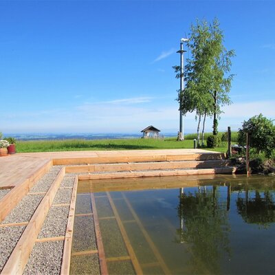new swimming pond with lounge area