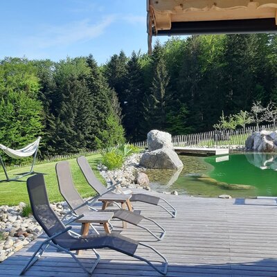 Swimming pond with lounge chairs