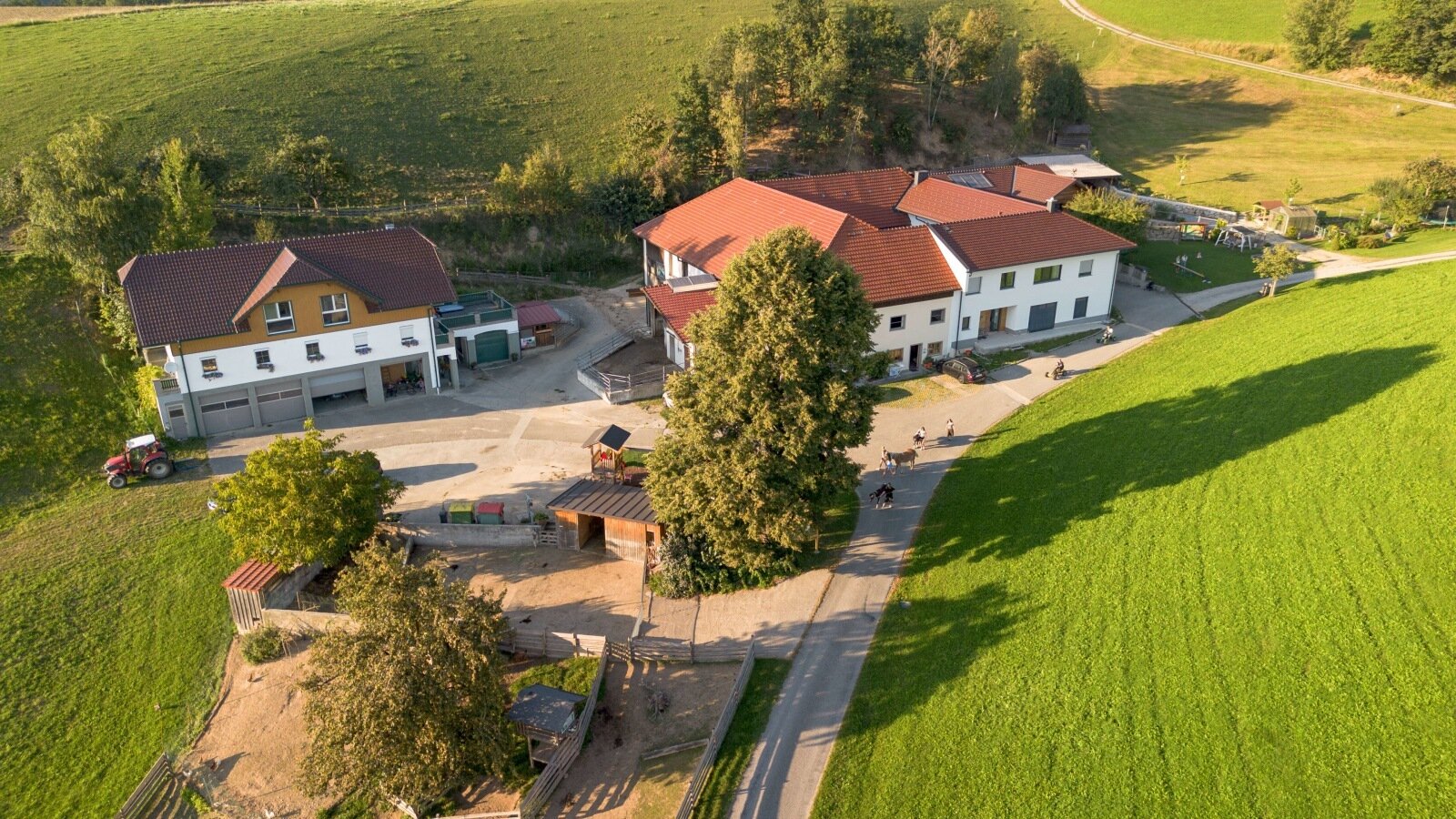 Aerial view of the farmhouse, surrounded by green fields
