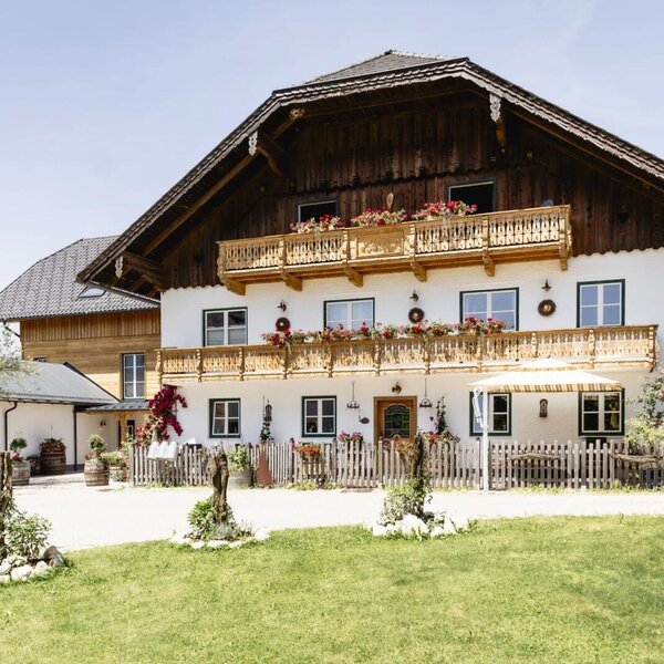 Exterior view of the Appartements building with traditional architecture, wooden balconies, and flower boxes.