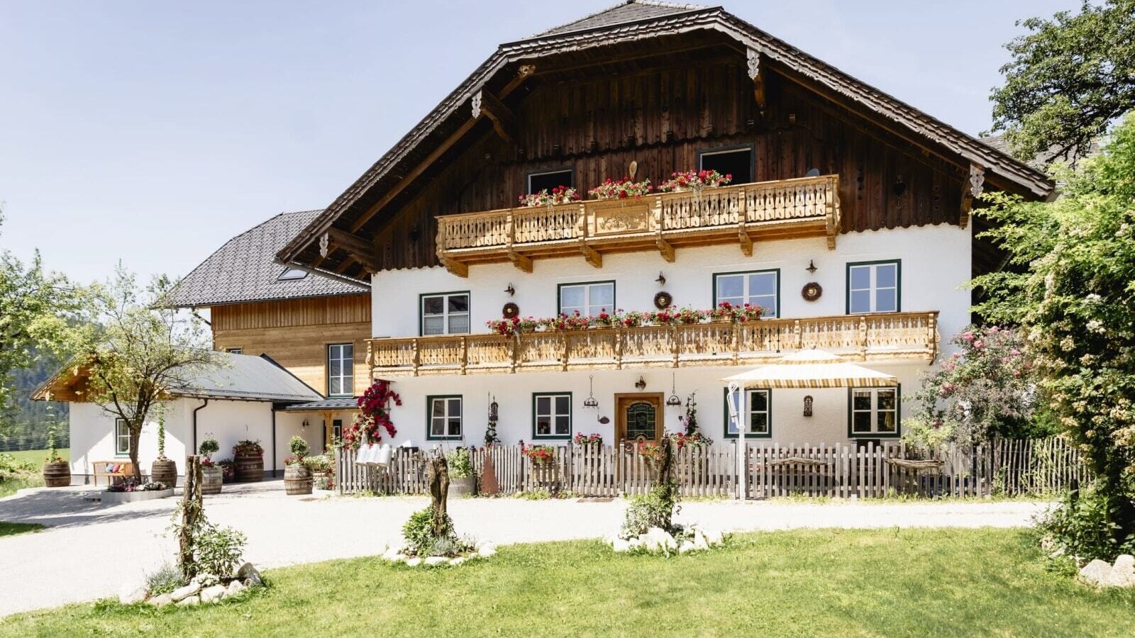 Exterior view of the Appartements building with traditional architecture, wooden balconies, and flower boxes.
