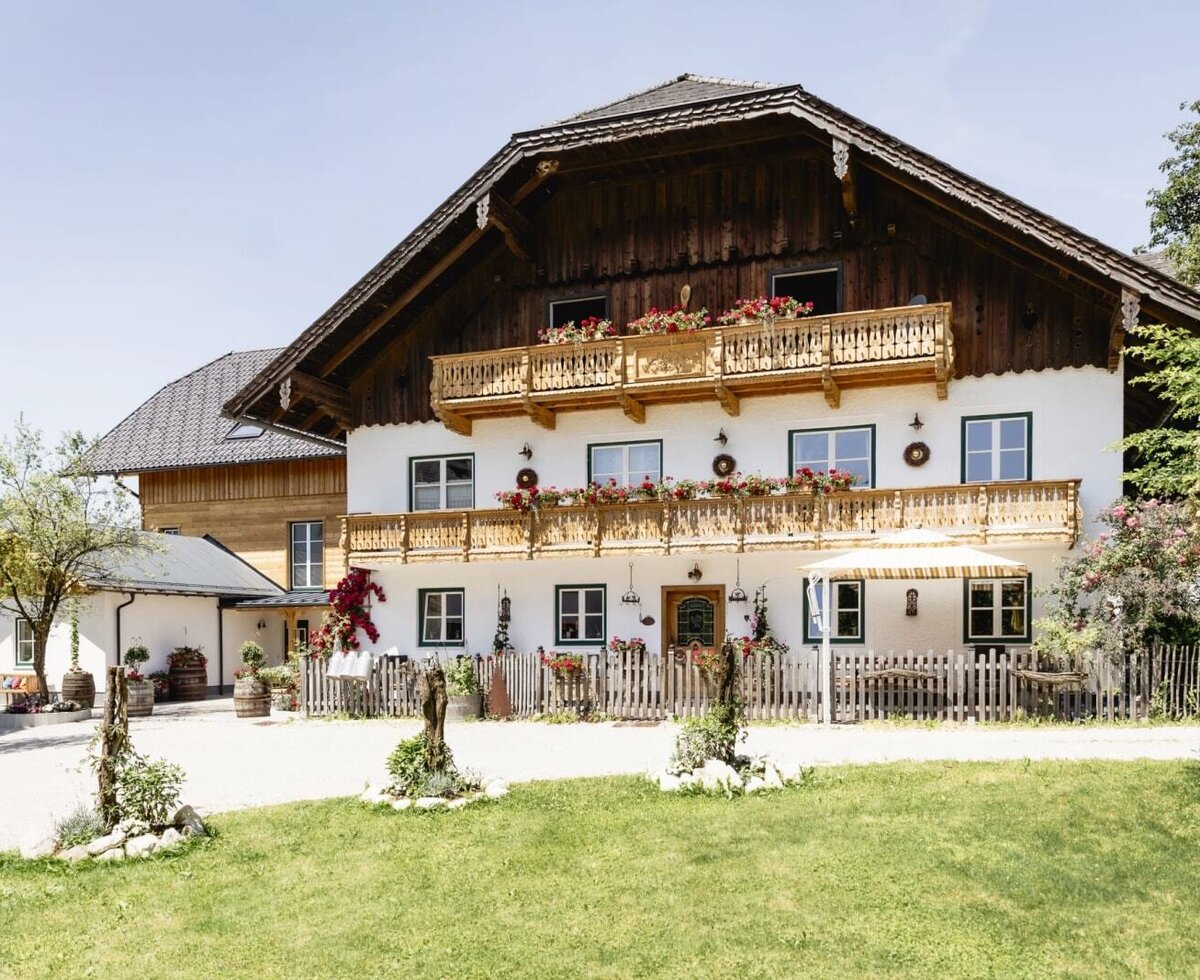 Exterior view of the Appartements building with traditional architecture, wooden balconies, and flower boxes.