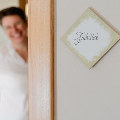 The farmhouse's inviting breakfast area, marked by a charming, hand-lettered sign.