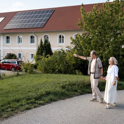 The inviting farmhouse features a spacious green lawn, perfect for relaxing outdoor strolls.