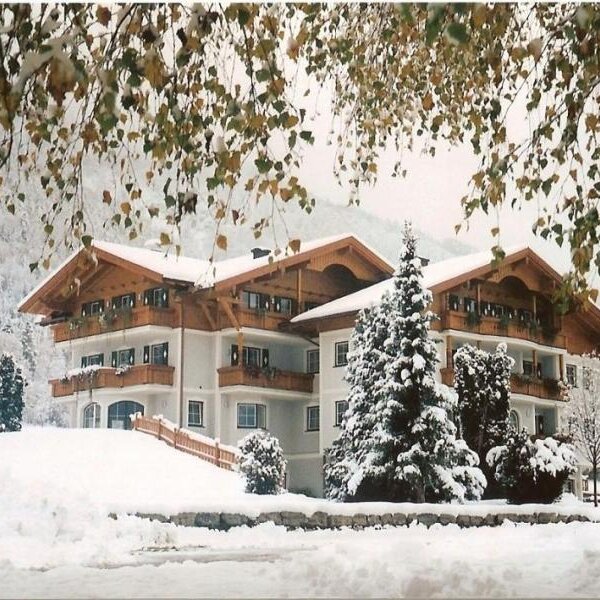 The snow-covered exterior of the farmhouse, featuring multiple balconies and traditional wooden eaves. The snow-covered exterior of the farmhouse, featuring multiple balconies and traditional wooden eaves.