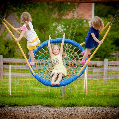 Children's play area with a large net swing at the farm house.