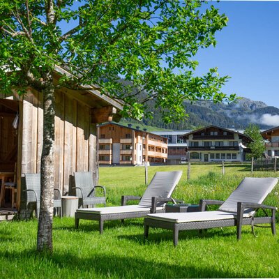 Guests can enjoy the farm house garden, equipped with sun loungers and a shaded outdoor seating area, with views of the surrounding mountains.