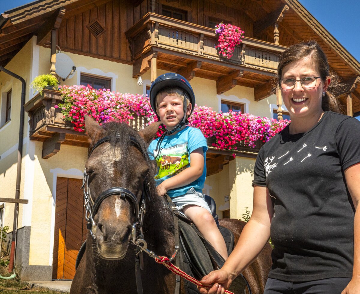 The charming apartment featuring flower-filled balconies offers a family-friendly experience with pony riding right outside.