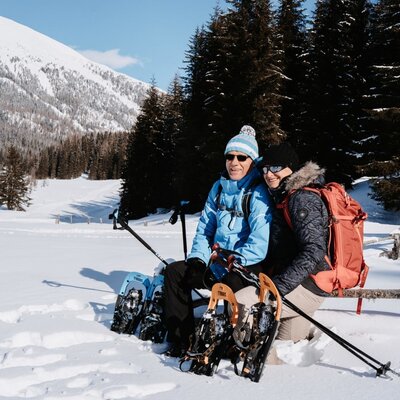 Snowshoers in a snowy mountain landscape, illustrating winter activities available near the farmhouse.