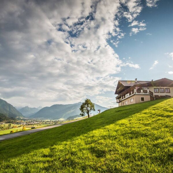 The Bed and Breakfast on a green hillside with views of the valley and mountains.